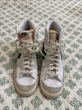 Nike White High-Top Sneakers with Black Swoosh and Red Logo